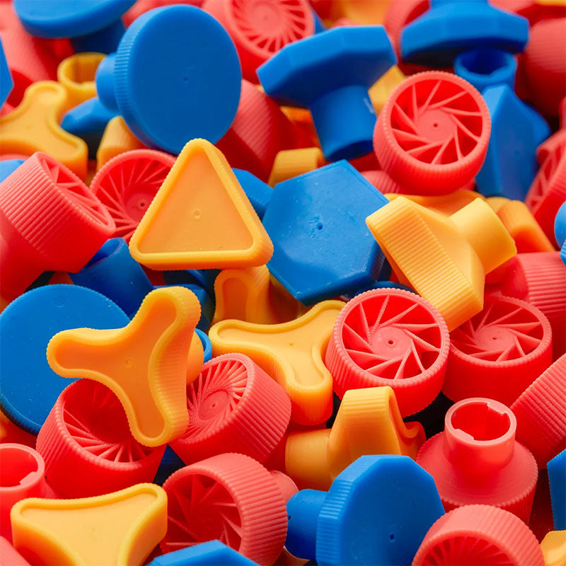 Colorful plastic bottle caps in various shapes and sizes.