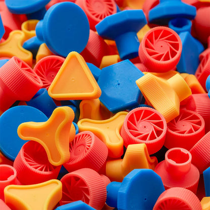 Colorful plastic bottle caps in various shapes and sizes.