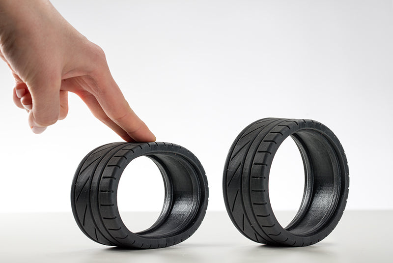 Hand interacting with 3D printed tire.